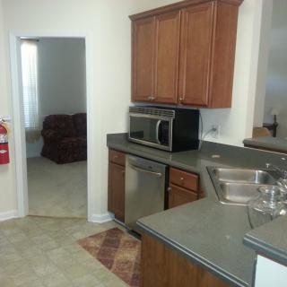 A modern kitchen with wooden cabinets and stainless steel appliances.