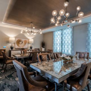 A luxurious dining room with elegant chandeliers and a stylish table setup.