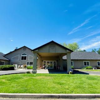 A welcoming entrance to a well-designed building under a clear blue sky.