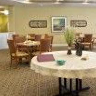 A well-arranged dining room with tables and chairs, featuring tasteful decor.