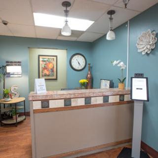 A welcoming reception area featuring modern decor and a calming blue color scheme.