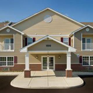 A two-story building with a prominent entrance and traditional architecture design.