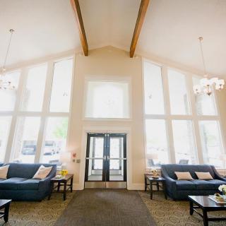A spacious and bright lobby with high ceilings and large windows.