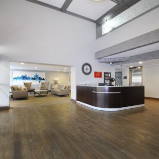 Modern office lobby with a reception desk and waiting area.