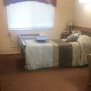 A small, cozy bedroom with a single bed near a window.