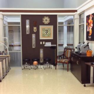 A well-decorated waiting room with chairs and various artworks adorning the walls.