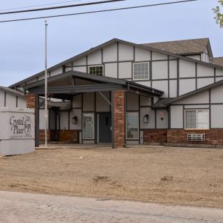A front view of a building with brick and wood exterior on a clear day.