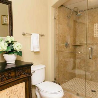 Elegant bathroom with a glass-enclosed shower and decorative vanity.