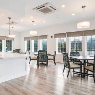 A modern open dining area with ample natural light and contemporary furniture.