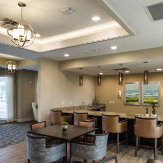 A modern dining area featuring elegant chandeliers and cozy seating arrangements.