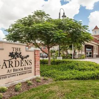 The entrance to The Gardens at Brook Ridge, featuring a welcoming sign and well-maintained landscaping.