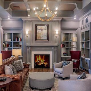 A beautifully decorated living room with a cozy fireplace and elegant furnishings.