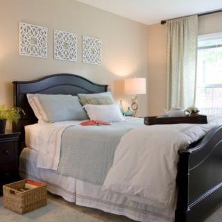 A cozy and well-decorated bedroom with a neatly made bed, stylish decor, and soft lighting.
