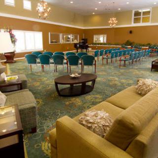 A spacious lobby area with seating arrangements and chandeliers.