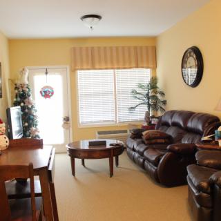 Cozy living room with a sofa, table, and decor next to a large window.