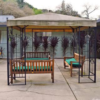 A cozy gazebo setup with benches on a patio.