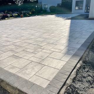 A newly paved outdoor patio with a patterned concrete surface.