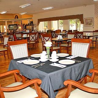 An elegant restaurant dining area with neatly set tables and comfortable chairs.