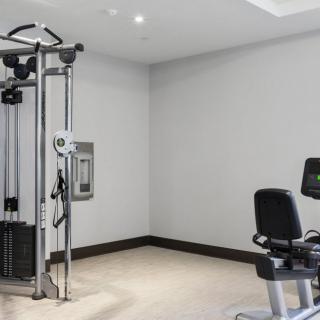 A well-equipped gym space with various exercise machines for fitness enthusiasts.