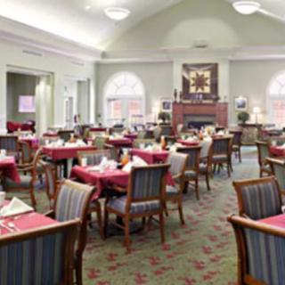 An elegant dining room with neatly arranged tables and chairs, ready for service.