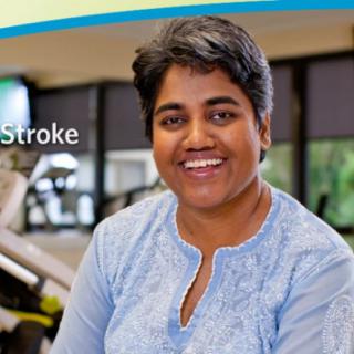 A person smiling indoors at a fitness center.