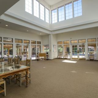 Spacious library interior with large windows and natural light.
