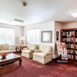 Cozy living room with sofas, a bookshelf, and a coffee table.