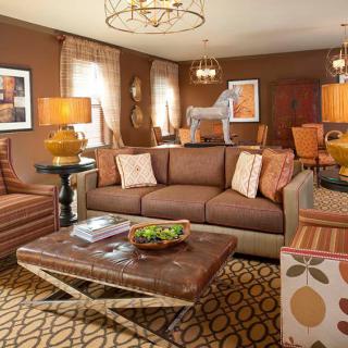 A cozy living room with a brown color scheme, featuring a comfortable sofa, stylish coffee table, and warm lighting.