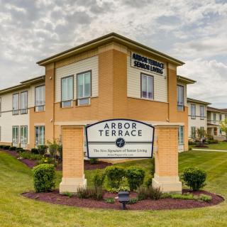 A senior living facility with well-maintained landscaping under a cloudy sky.