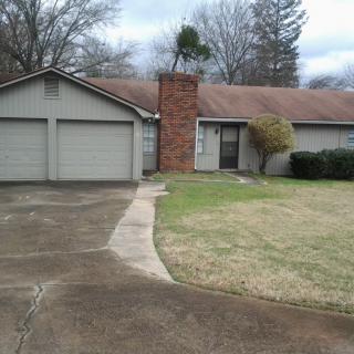 A suburban house with a two-car garage and a front lawn.