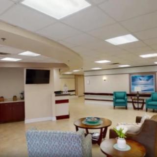 A spacious and well-lit hospital waiting room with comfortable seating and modern decor.