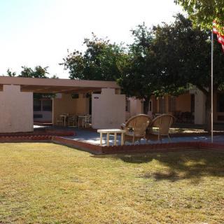 A mid-century modern house with a patio and seating area in the backyard.