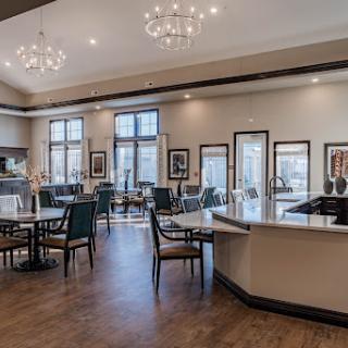 A stylish and modern lounge area featuring elegant chandeliers and a cozy seating arrangement.