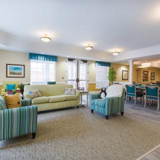 A brightly lit living room with comfortable seating and tasteful decorations.