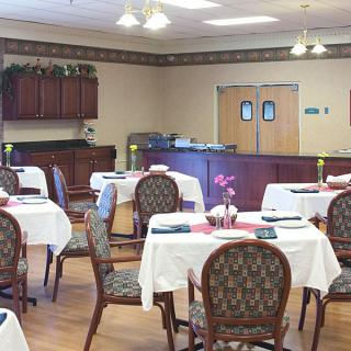 A cozy dining room with neatly arranged tables and chairs, ready for guests.