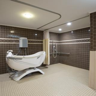 A spacious modern bathroom featuring a sleek bathtub and shower, designed for comfort and accessibility.
