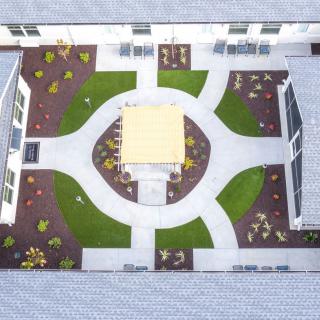 Aerial view of a symmetrically designed courtyard with pathways and garden areas.