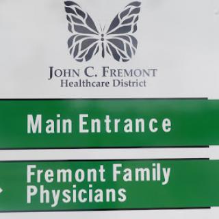 Signage indicating the main entrance and family physicians at John C. Fremont Healthcare District.