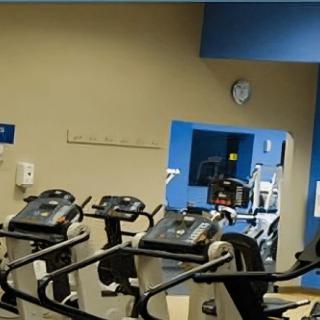 A gym with treadmills and exercise equipment.