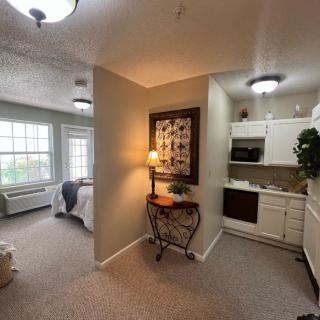 A cozy apartment with a bedroom and kitchenette.