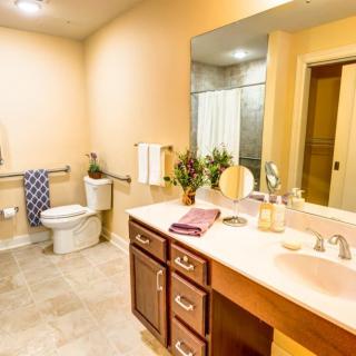 Modern bathroom with a sink, mirror, and toilet.
