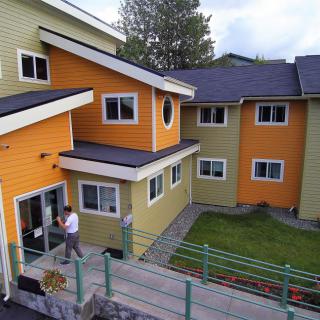 A modern, colorful residential building with a unique architectural design.