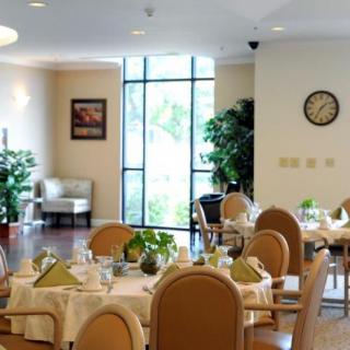 An elegant dining area with neatly set tables, comfortable chairs, and natural decor.