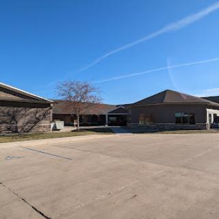 A view of a modern building with a clear blue sky above.