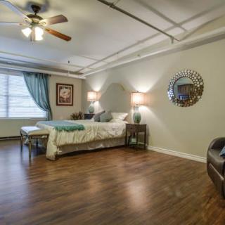 A modern bedroom with wooden floors, a double bed, and stylish decor.