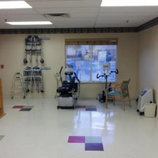 A physical therapy room equipped with exercise machines and tools.