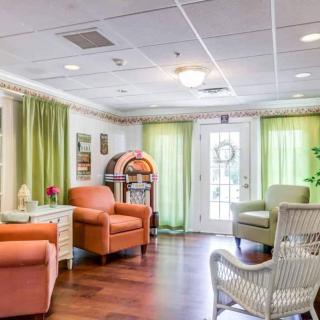 A cozy living area with colorful chairs and natural lighting.