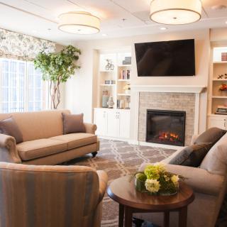 A cozy and modern living room featuring a fireplace and comfortable seating.