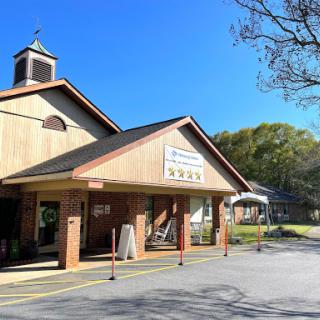 A charming wooden building under a clear blue sky.