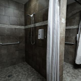 A modern shower area with tiled walls and a clean design.